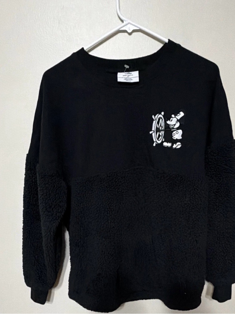 Disney fleece Women’s Black Crewneck Sweater with White Cartoon Wheel Graphic